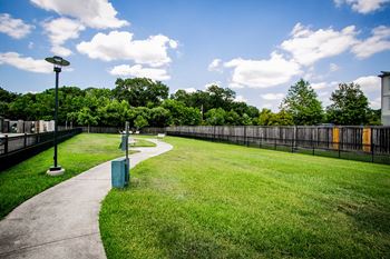 a park with a grassy area and a fence